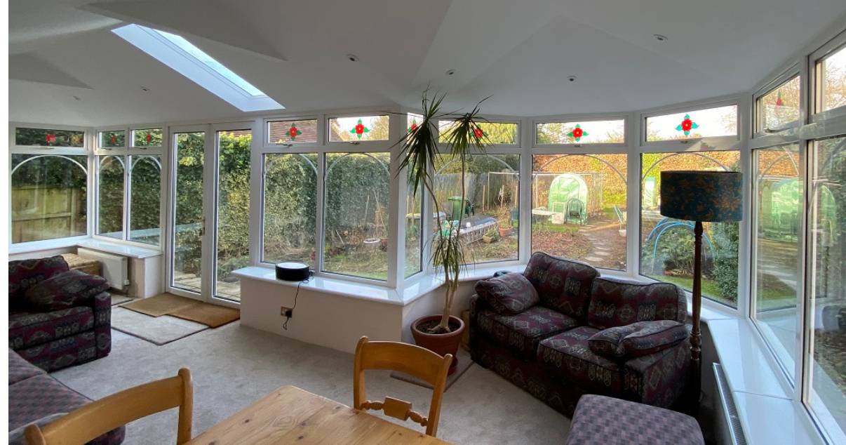 comfortable dinning and living area after warm conservatory transformation 